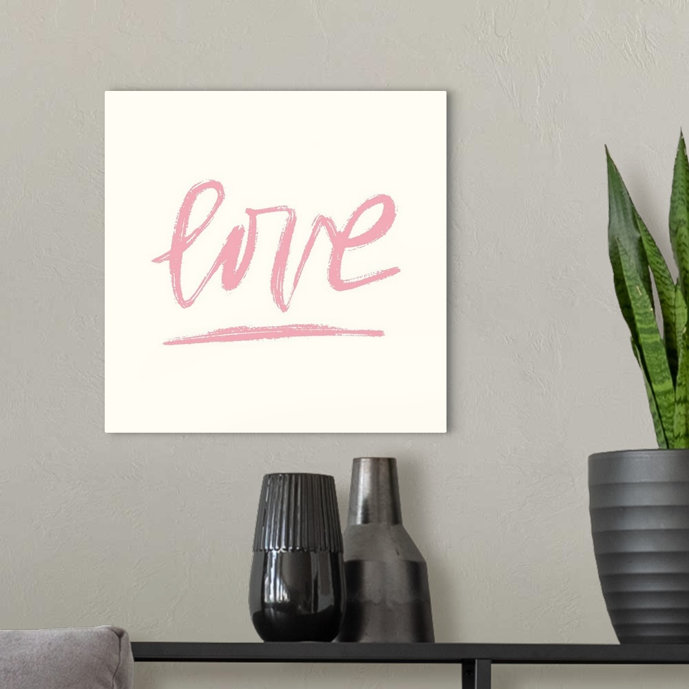 A modern room featuring Handwritten word "Love" in pink on a cream backdrop.