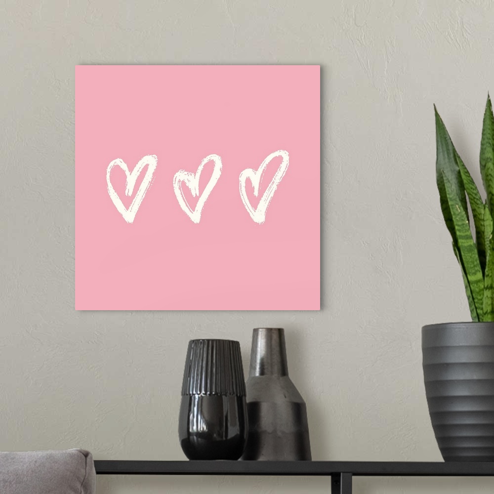 A modern room featuring Cream colored row of hearts on a pink backdrop.