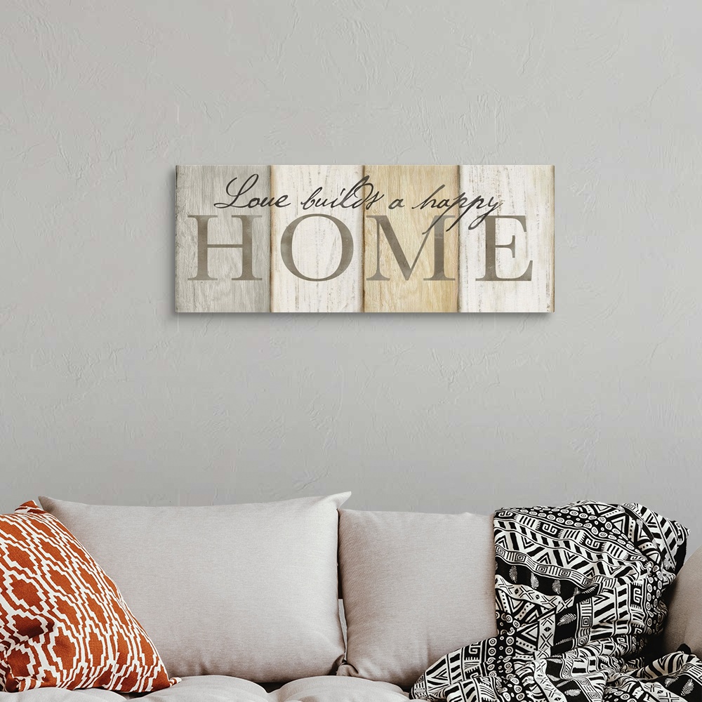 A bohemian room featuring "Love builds a happy Home" on a neutral multi-colored wood plank background.