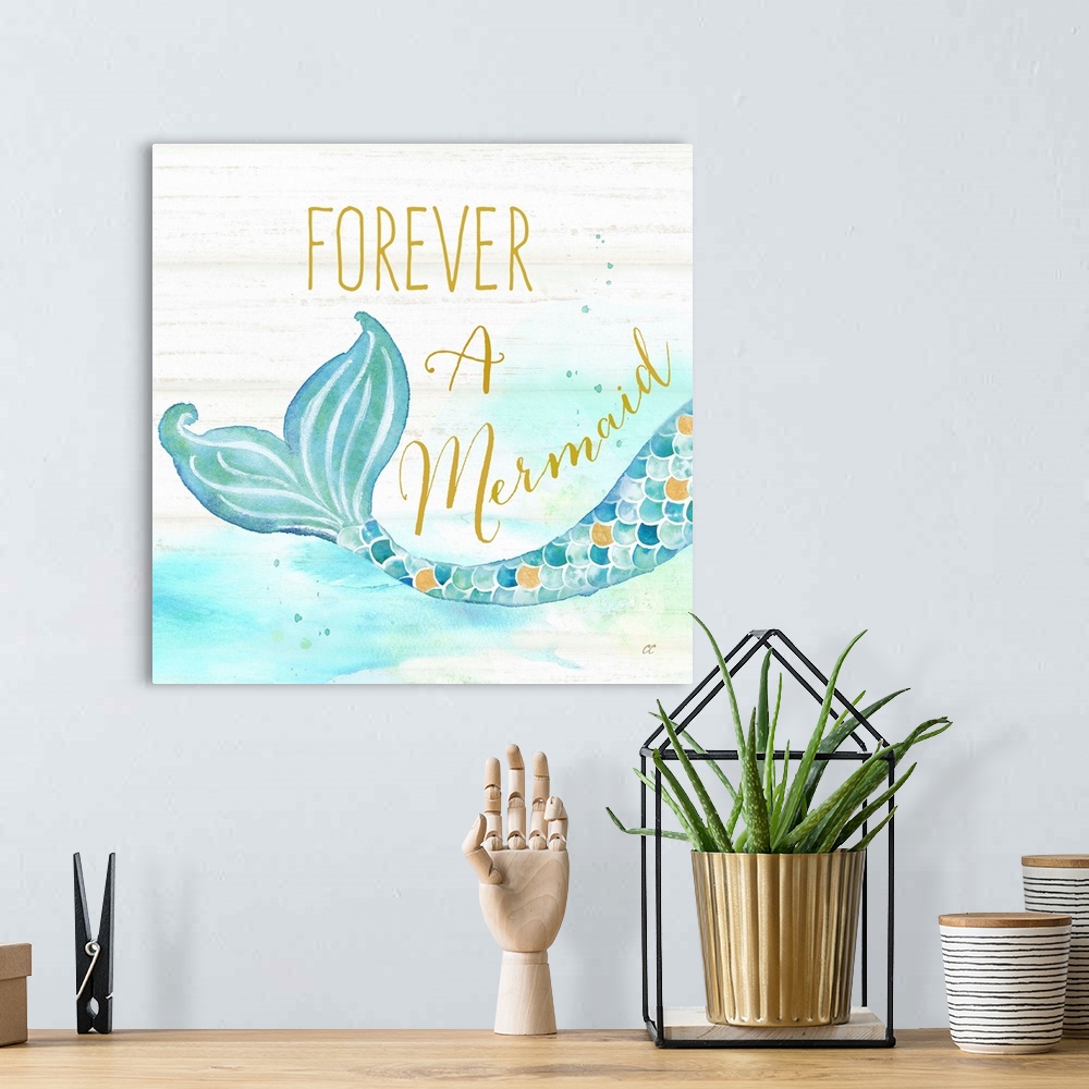 A bohemian room featuring "Forever A Mermaid" in gold with a watercolor design of a mermaid tail against a white wood backd...