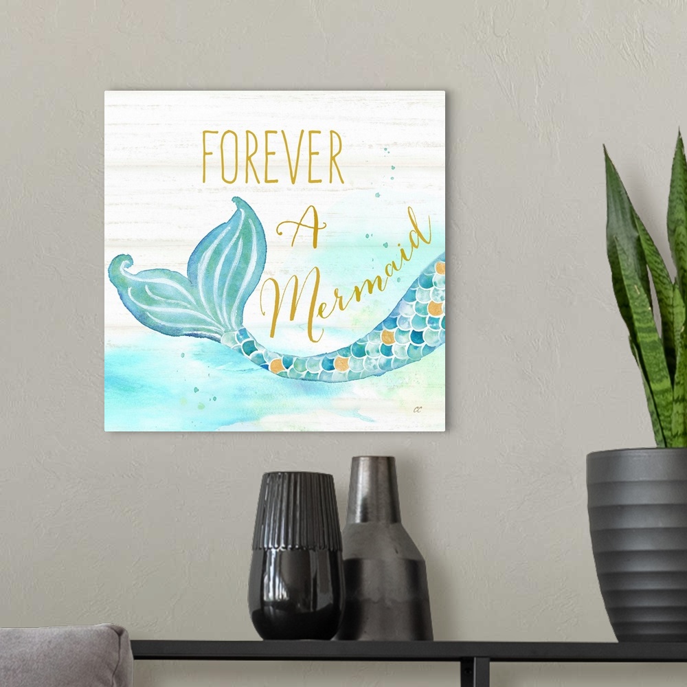 A modern room featuring "Forever A Mermaid" in gold with a watercolor design of a mermaid tail against a white wood backd...