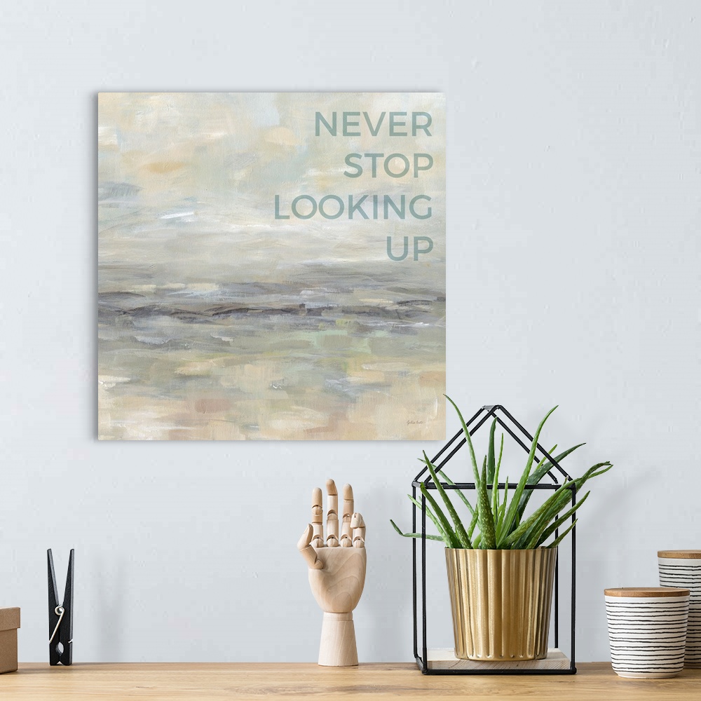 A bohemian room featuring "Never Stop Looking Up " on an abstract painting of textured neutral colors.