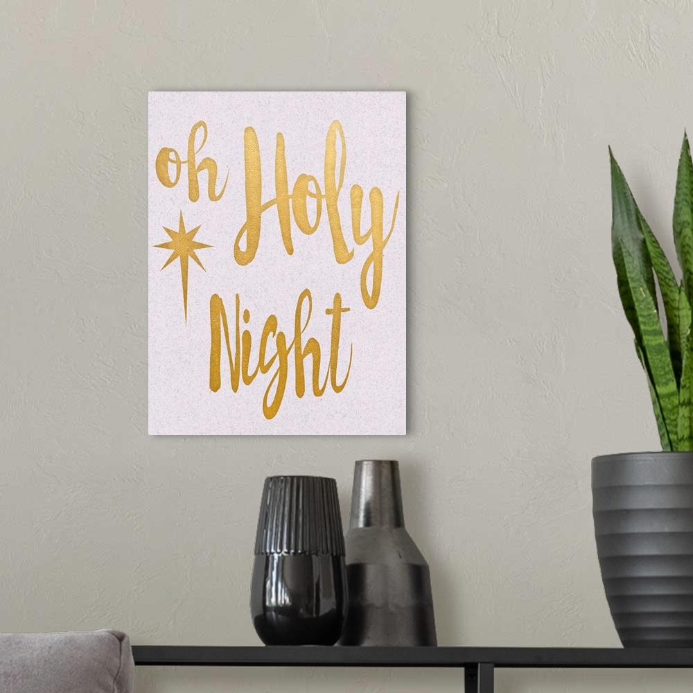 A modern room featuring "Oh Holly Night" in gold on a speckled white background.