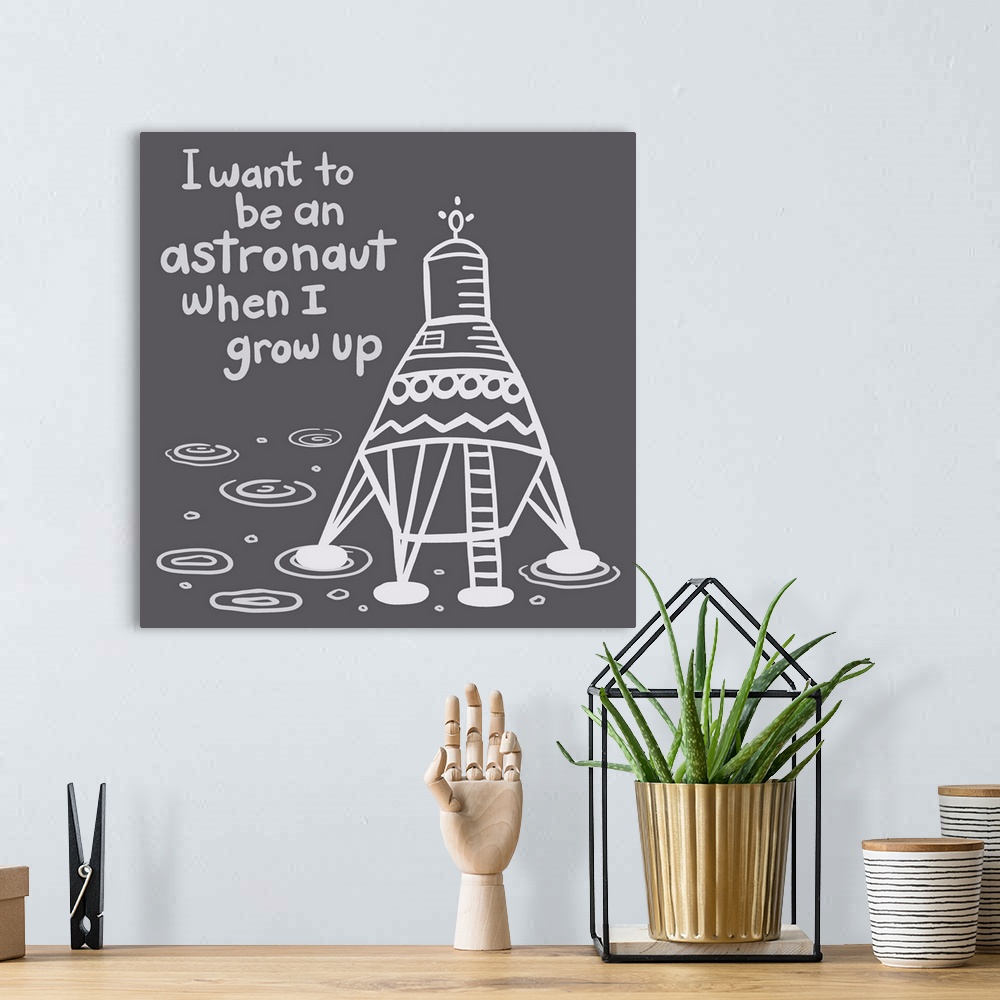 A bohemian room featuring "I want to be an astronaut when I grow up" with a space ship on a dark gray background.