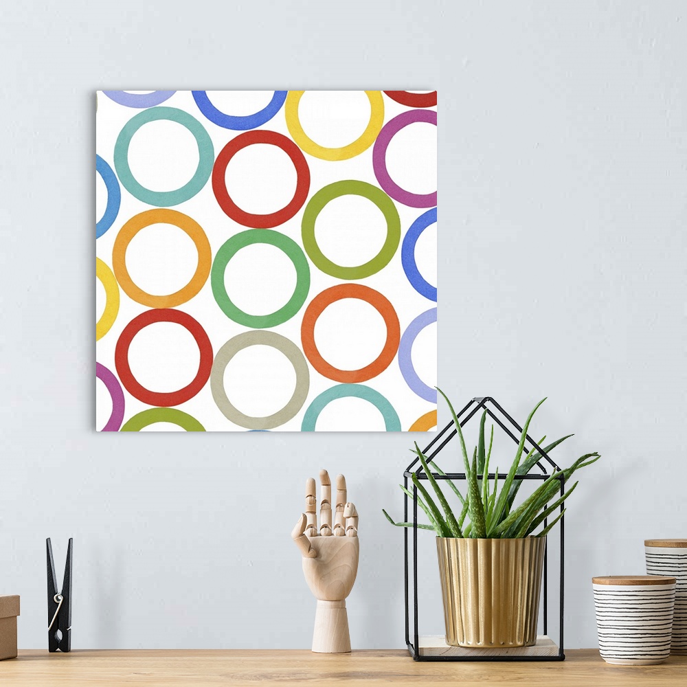 A bohemian room featuring Square decorative artwork of multi-colored circles in rows on a white background.