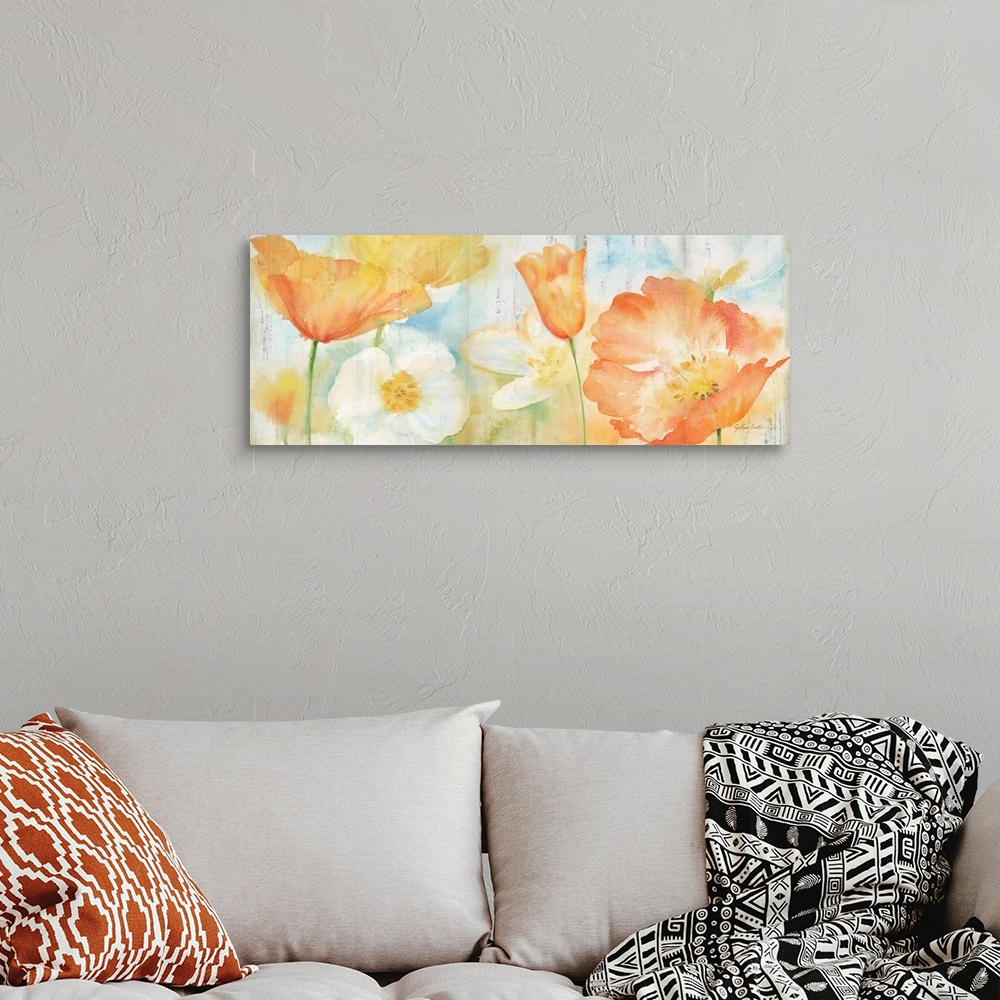 A bohemian room featuring A bright watercolor painting of white, orange and yellow poppies against a faded blue and green b...