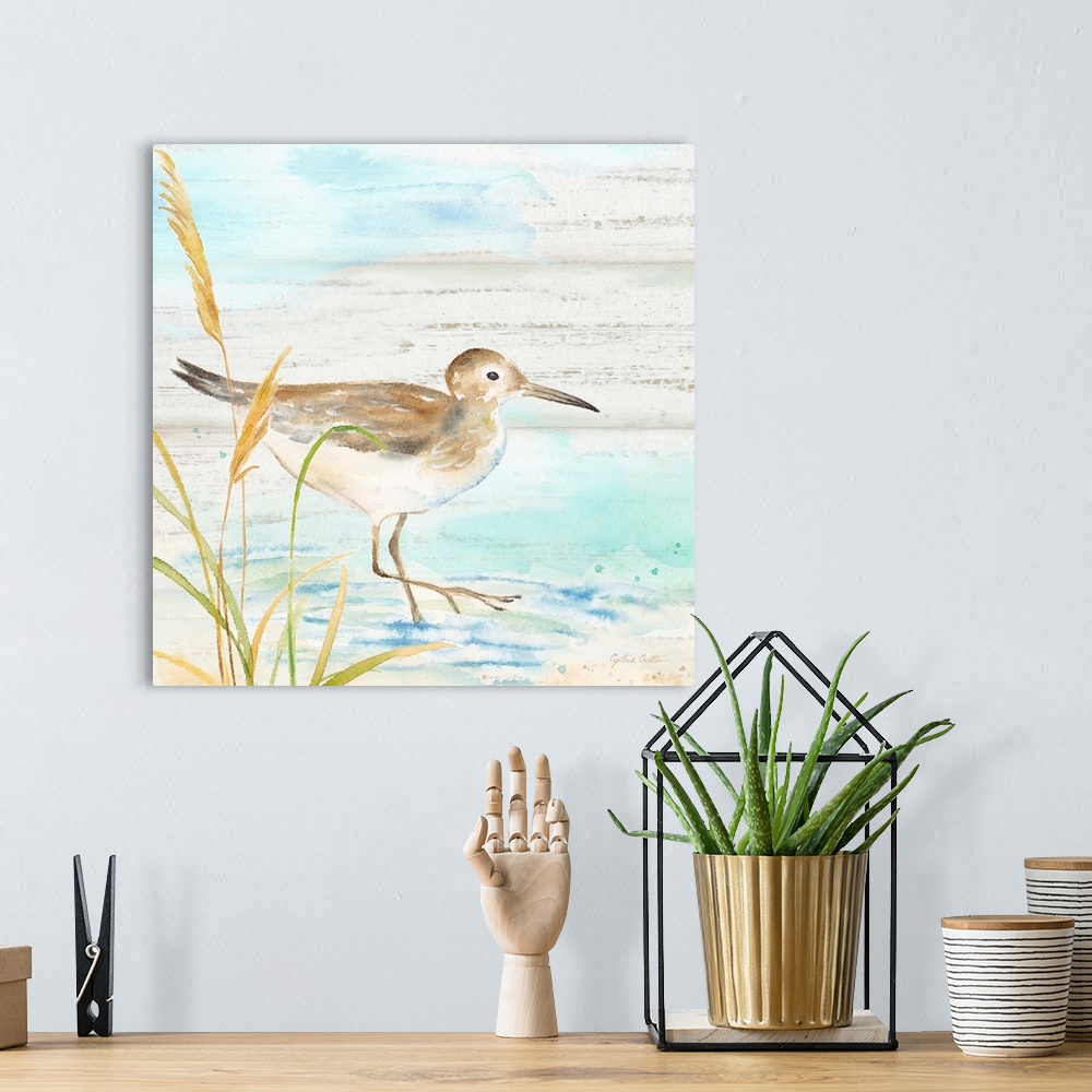 A bohemian room featuring A charming watercolor painting of a sandpiper walking on a beach.