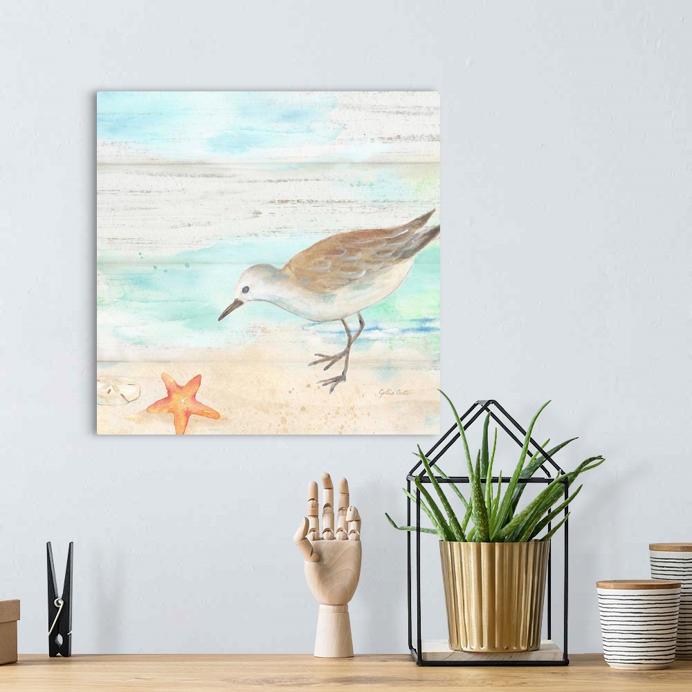 A bohemian room featuring A charming watercolor painting of a sandpiper walking on a beach.