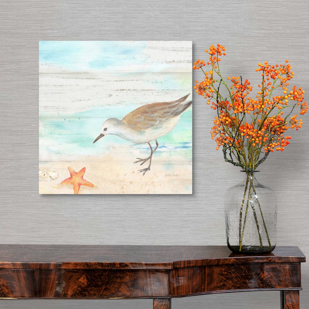 A traditional room featuring A charming watercolor painting of a sandpiper walking on a beach.