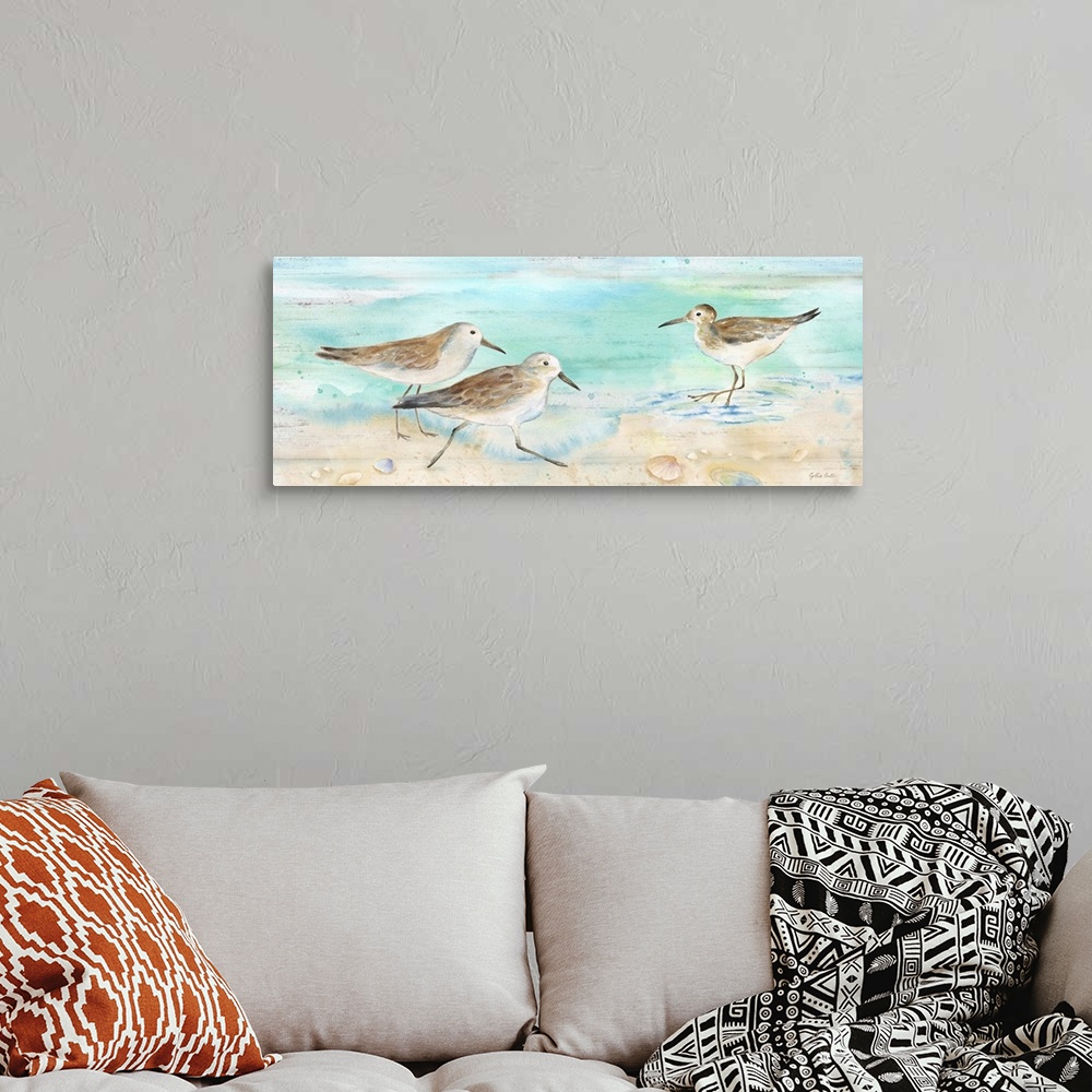 A bohemian room featuring A charming watercolor painting of sandpipers walking on a beach.