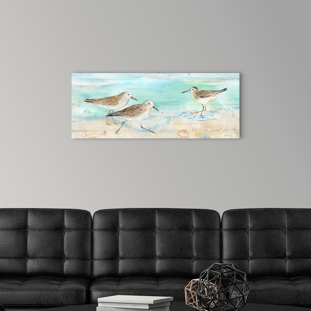 A modern room featuring A charming watercolor painting of sandpipers walking on a beach.