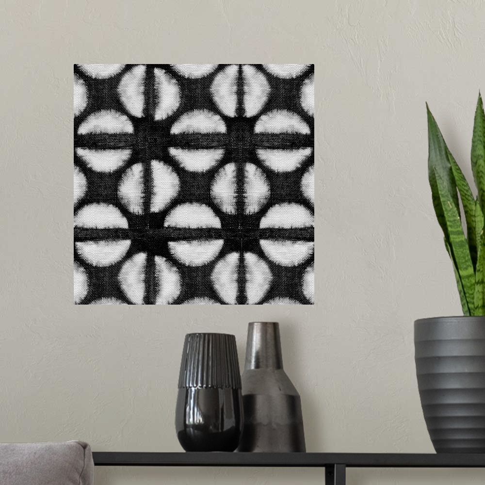 A modern room featuring Decorative design of rows of white circles with lines going through them on black linen.