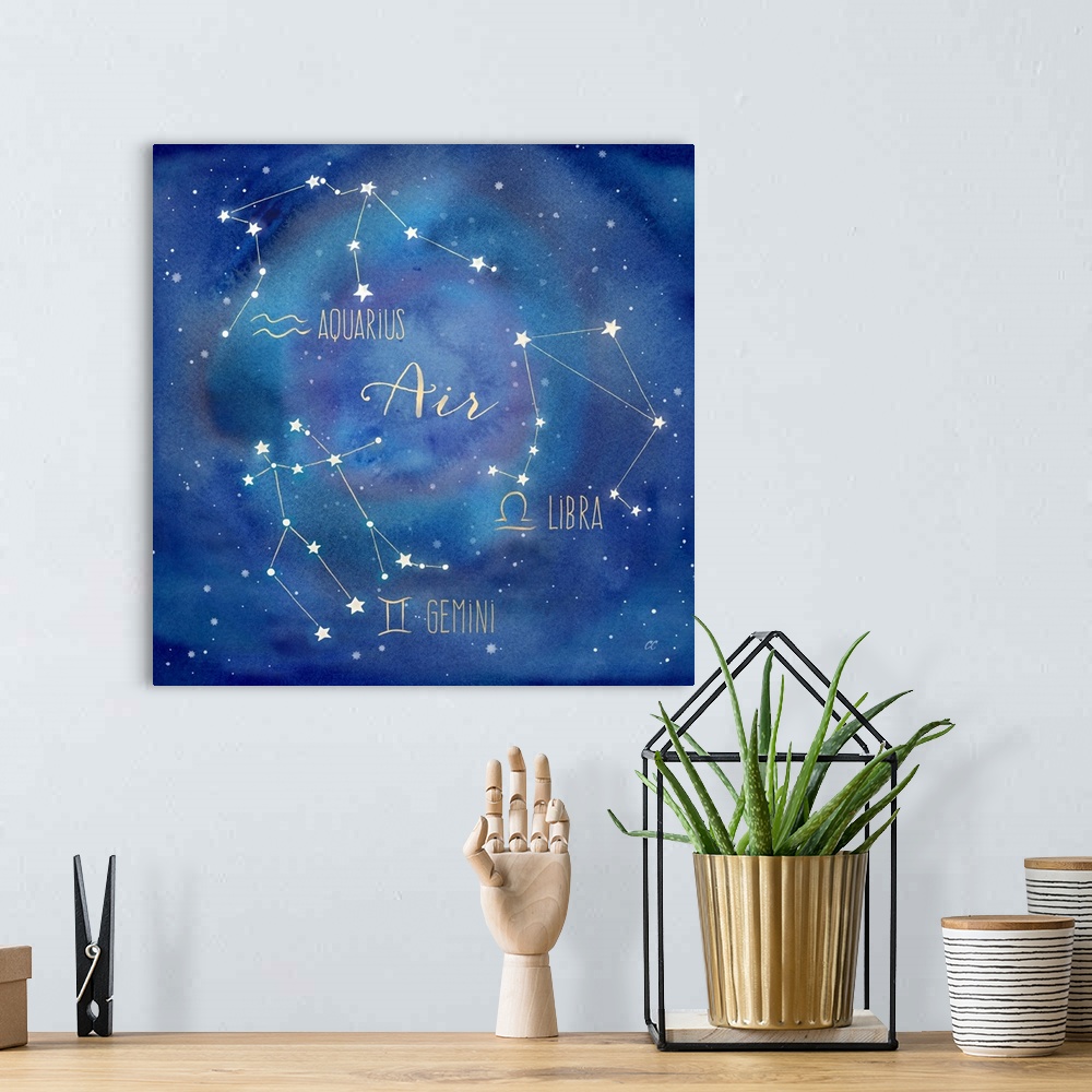A bohemian room featuring Square artwork of the constellations of Aquarius, Libra and Gemini with the symbols.