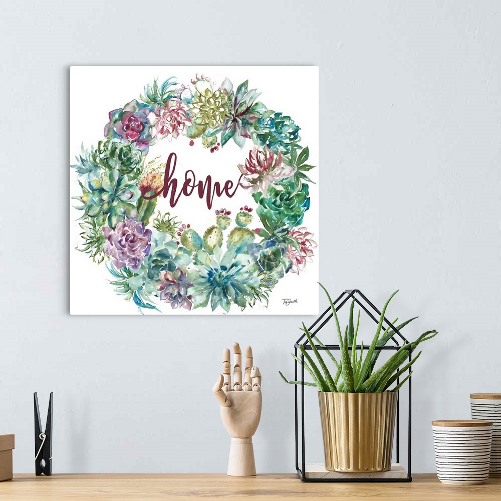 A bohemian room featuring "Home" on a square decorative watercolor painting of a wreath of colorful succulents.