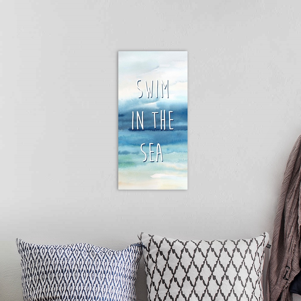 A bohemian room featuring "Swim In The Sea" in white on a watercolor painting of the ocean.