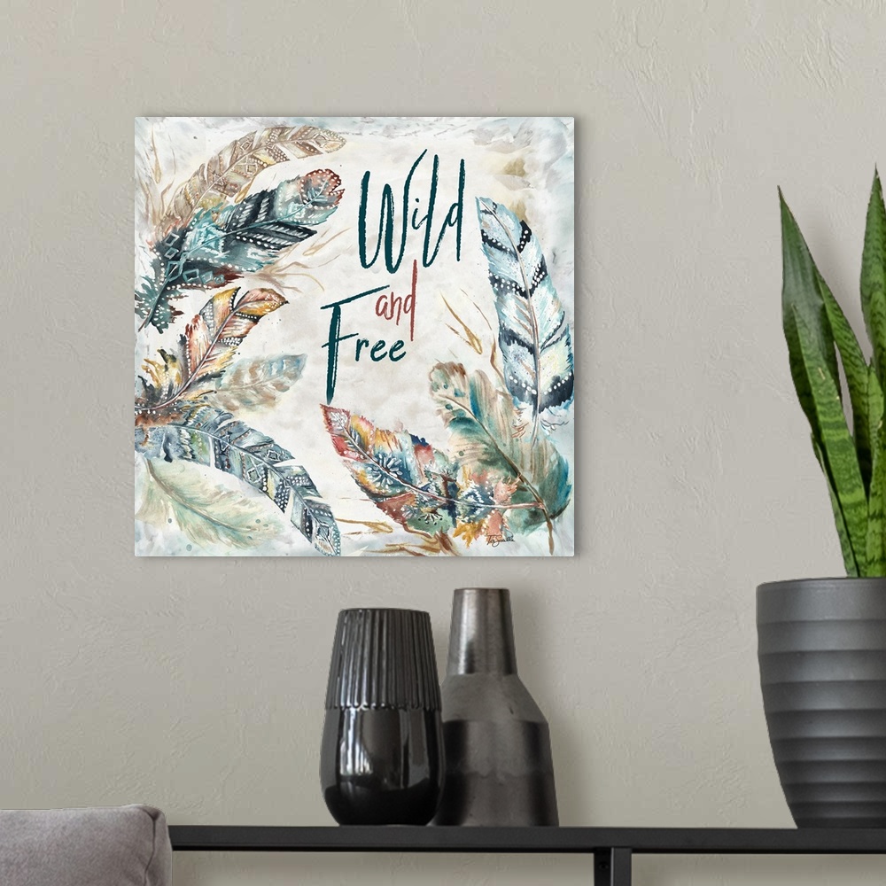 A modern room featuring A watercolor design of feathers with tribal patterns and the text "Wild and Free."