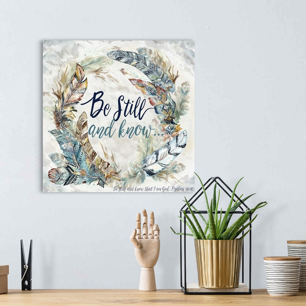 A bohemian room featuring A watercolor design of a wreath of feathers with tribal patterns and the text "Be Still and Know....