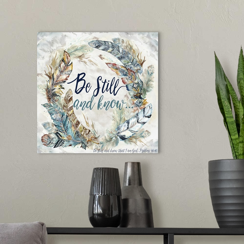 A modern room featuring A watercolor design of a wreath of feathers with tribal patterns and the text "Be Still and Know....