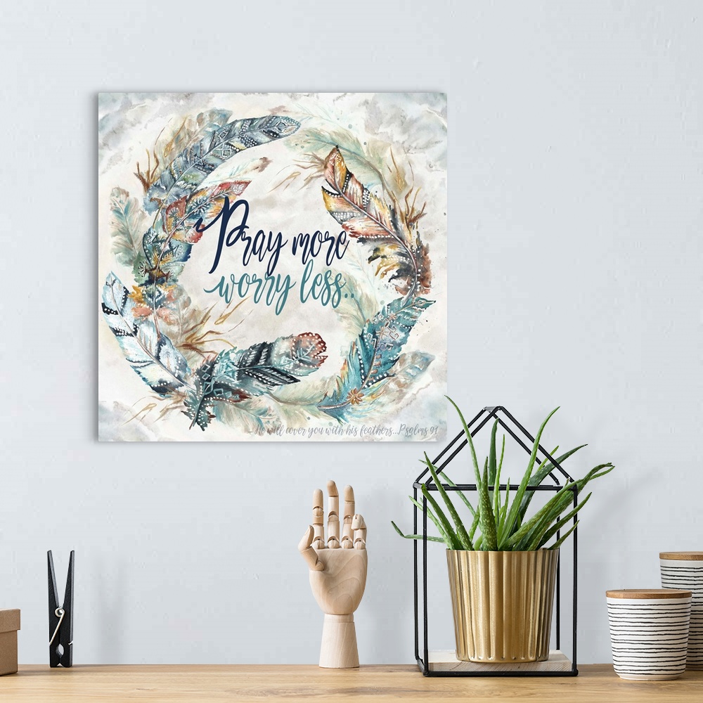 A bohemian room featuring A watercolor design of a wreath of feathers with tribal patterns and the text "Pray more worry le...