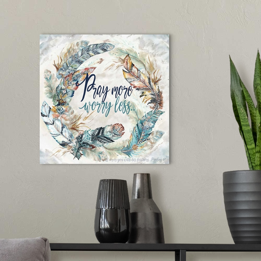 A modern room featuring A watercolor design of a wreath of feathers with tribal patterns and the text "Pray more worry le...