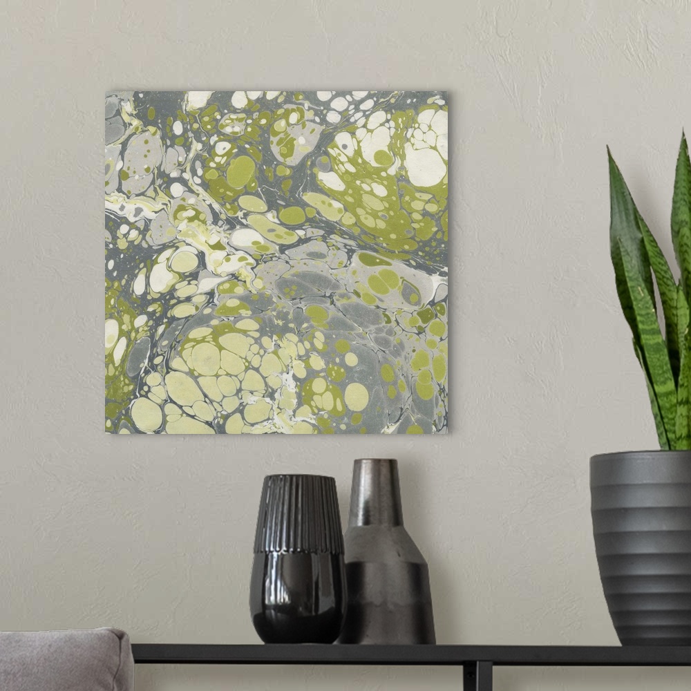 A modern room featuring Square abstract artwork of swirls of green, gray and white shades in a marble effect.