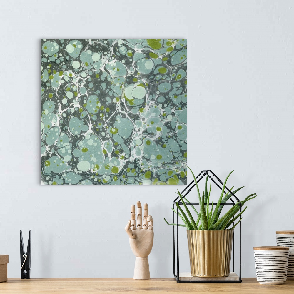 A bohemian room featuring Square abstract artwork of spots and swirls of green and blue shades in a marble effect.