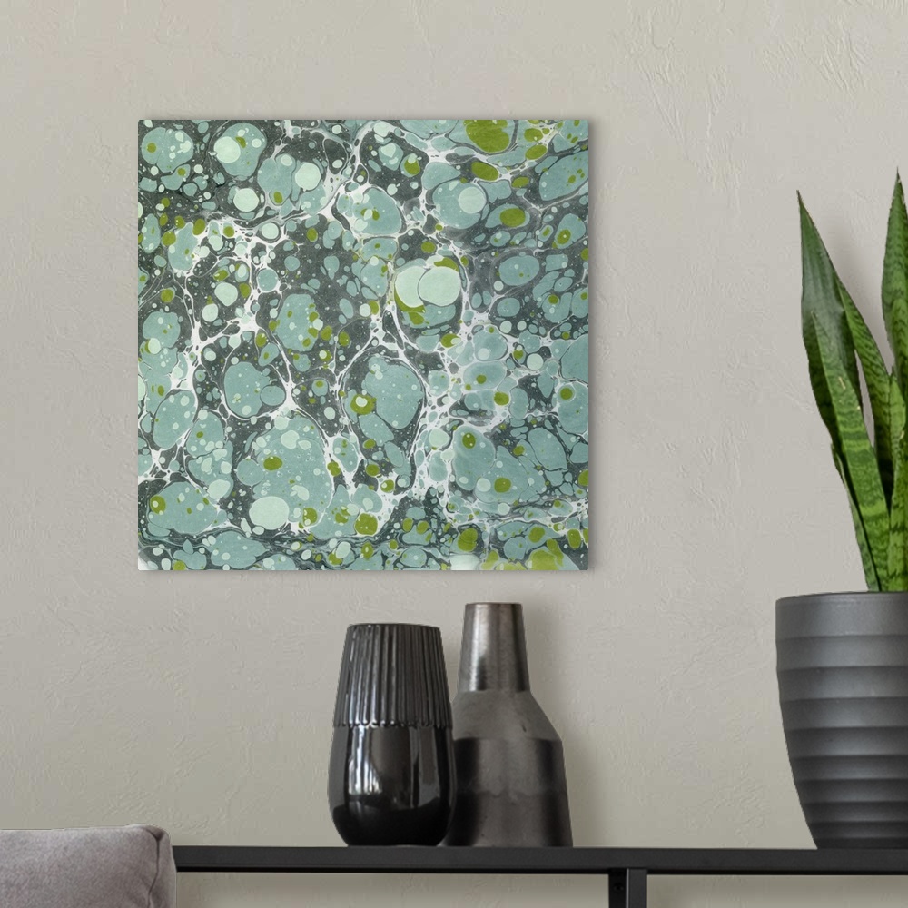A modern room featuring Square abstract artwork of spots and swirls of green and blue shades in a marble effect.