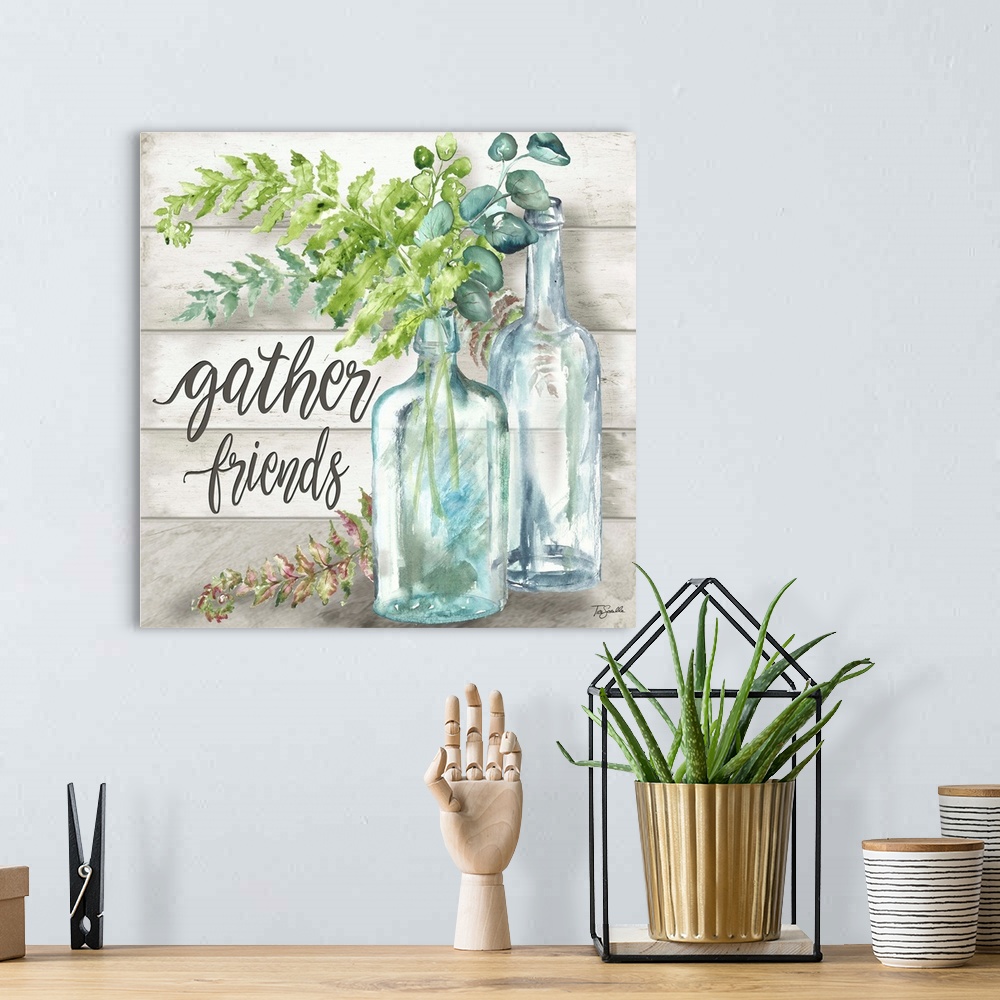 A bohemian room featuring "Gather Friends" with glass bottles and greenery on a gray wood panel background.
