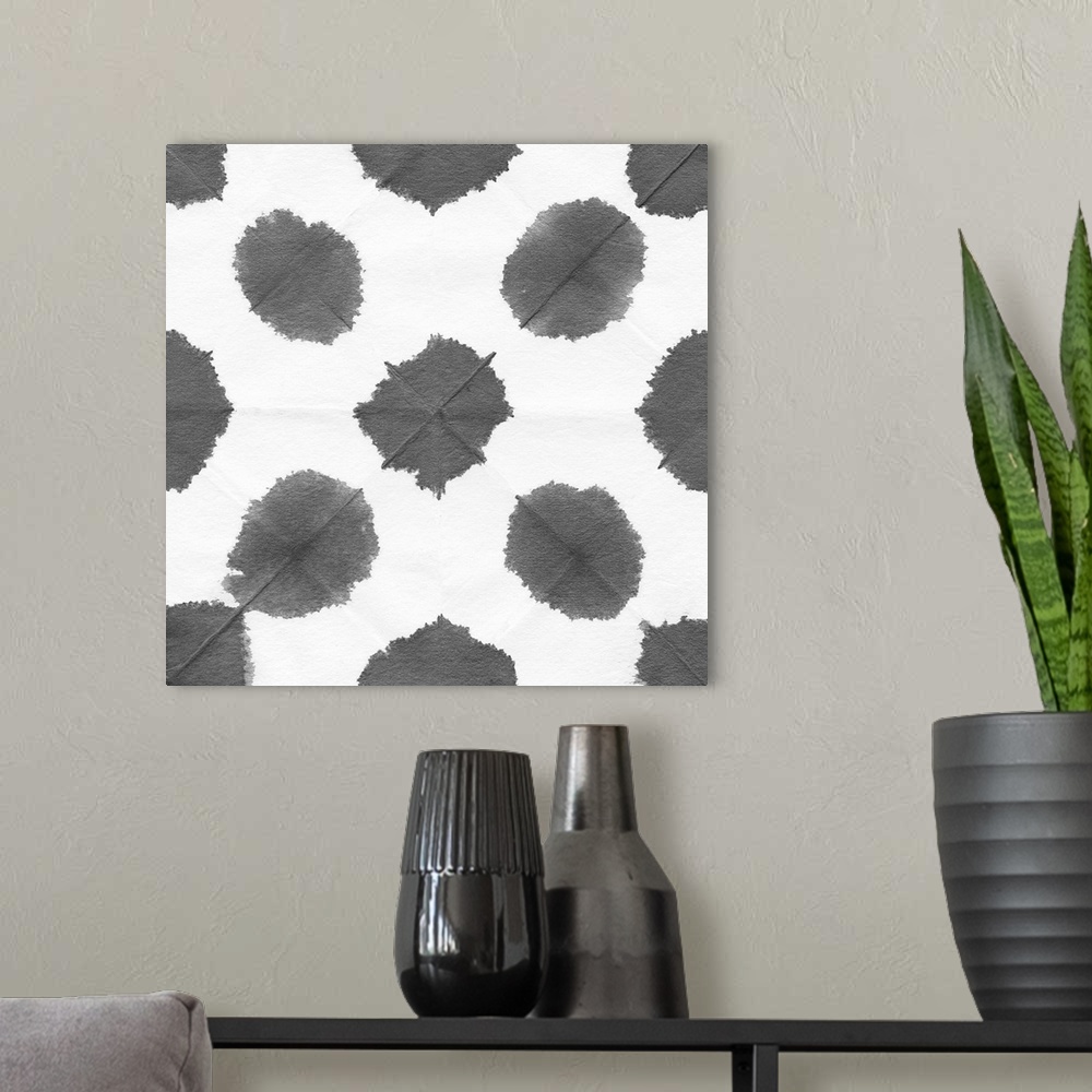 A modern room featuring Square decorative artwork of watercolor grey spots in rows on a white background.
