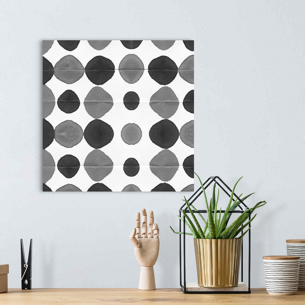 A bohemian room featuring Square decorative artwork of grey and black watercolor circles in rows on a white background.