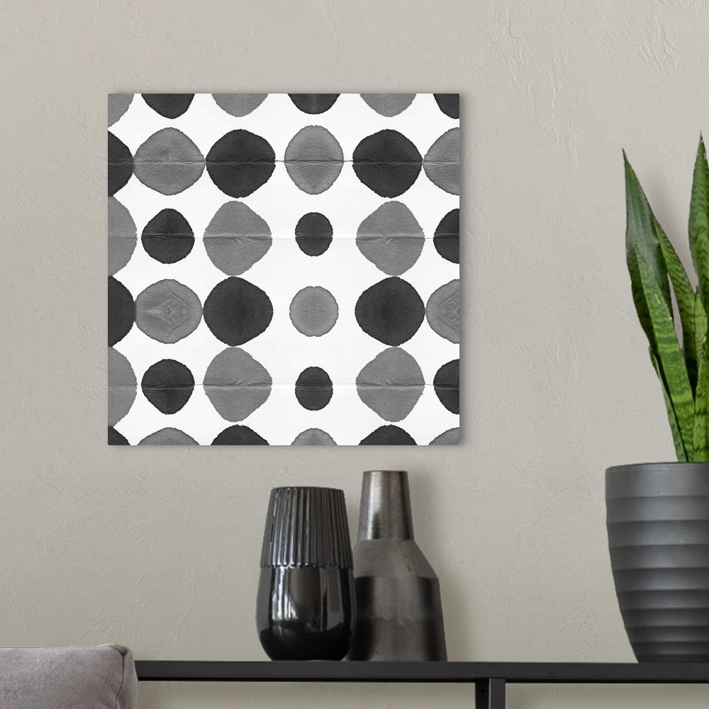 A modern room featuring Square decorative artwork of grey and black watercolor circles in rows on a white background.