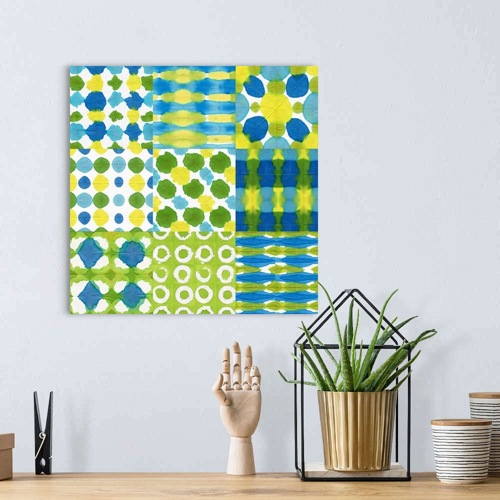 A bohemian room featuring A watercolor design of varies squares in different patterns of blue, green and yellow.