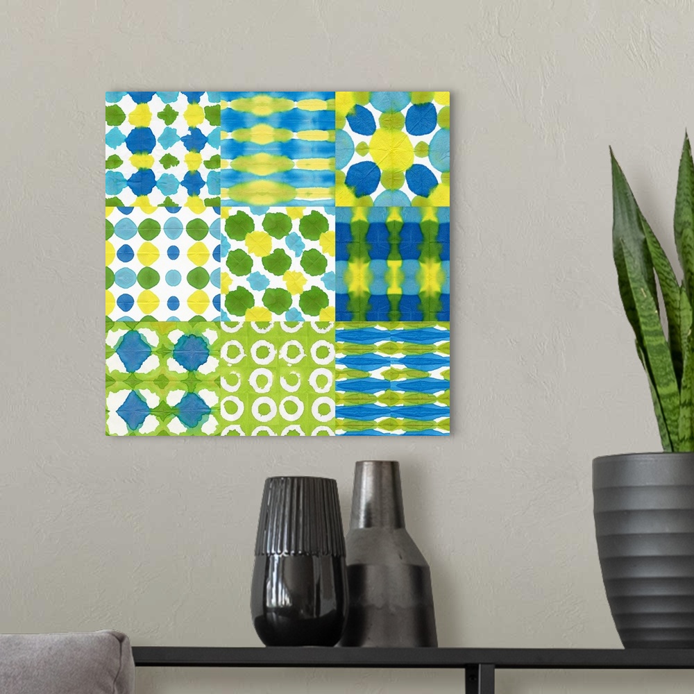 A modern room featuring A watercolor design of varies squares in different patterns of blue, green and yellow.