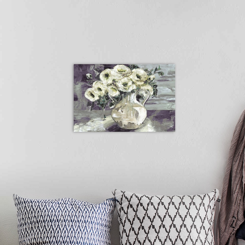 A bohemian room featuring A decorative painting of a pitcher full of white flowers in subdue tones.