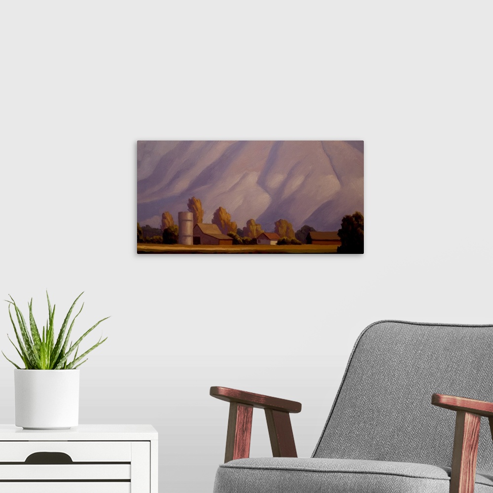 A modern room featuring Landscape painting of a farm with mountains in the background.