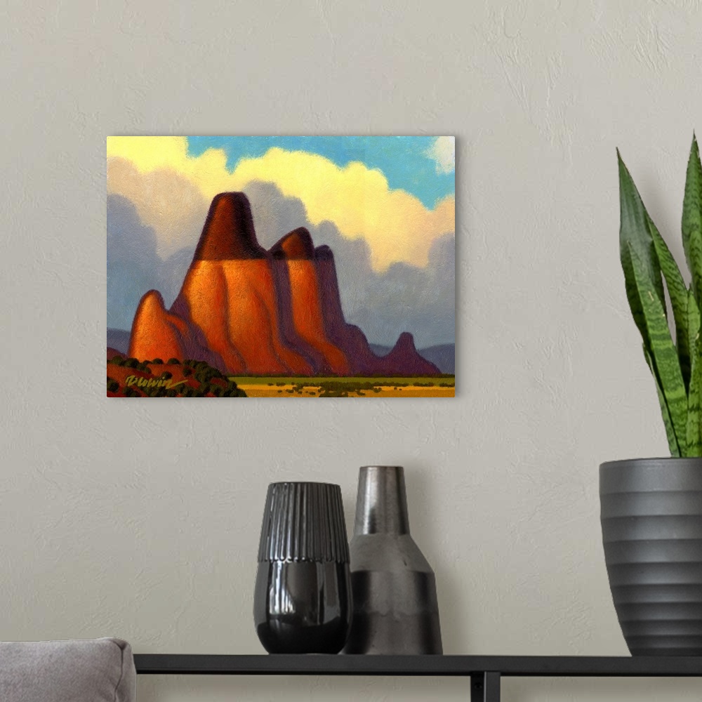 A modern room featuring Landscape painting of a desert butte with bright clouds.