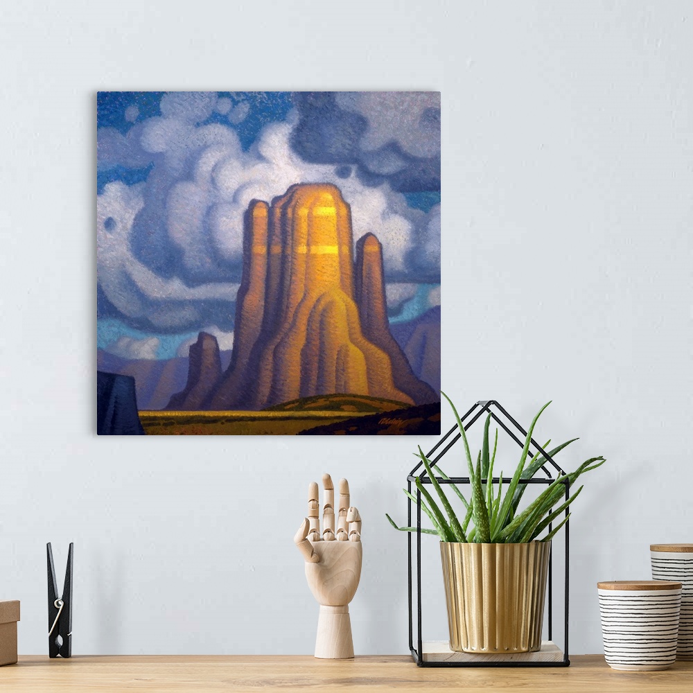 A bohemian room featuring Landscape painting of red rock with looming clouds.