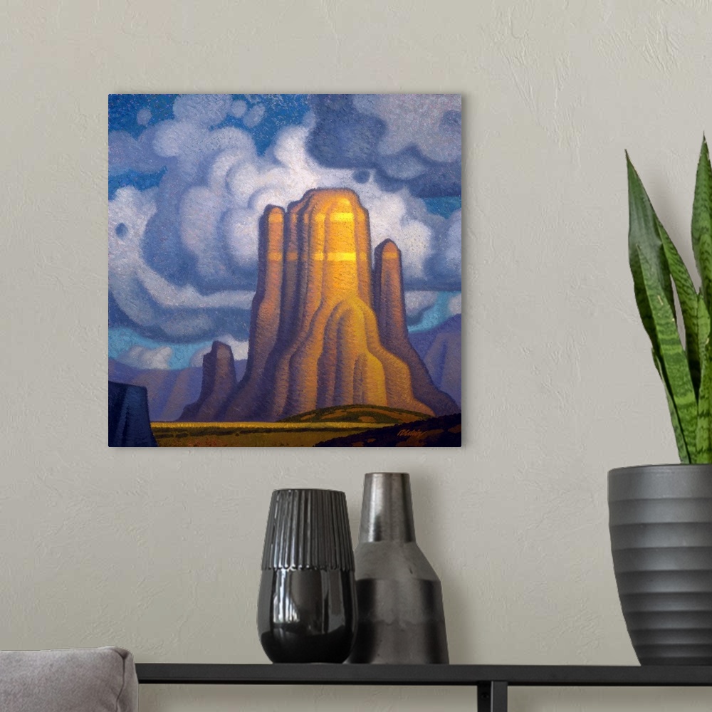 A modern room featuring Landscape painting of red rock with looming clouds.
