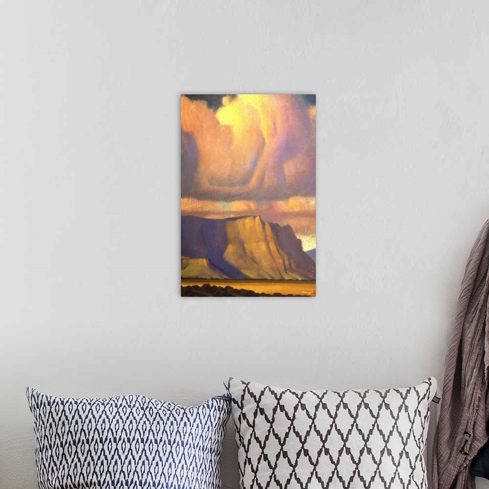 A bohemian room featuring Landscape painting of the Vermilion Cliffs of Northern Arizona with sunset colored clouds.