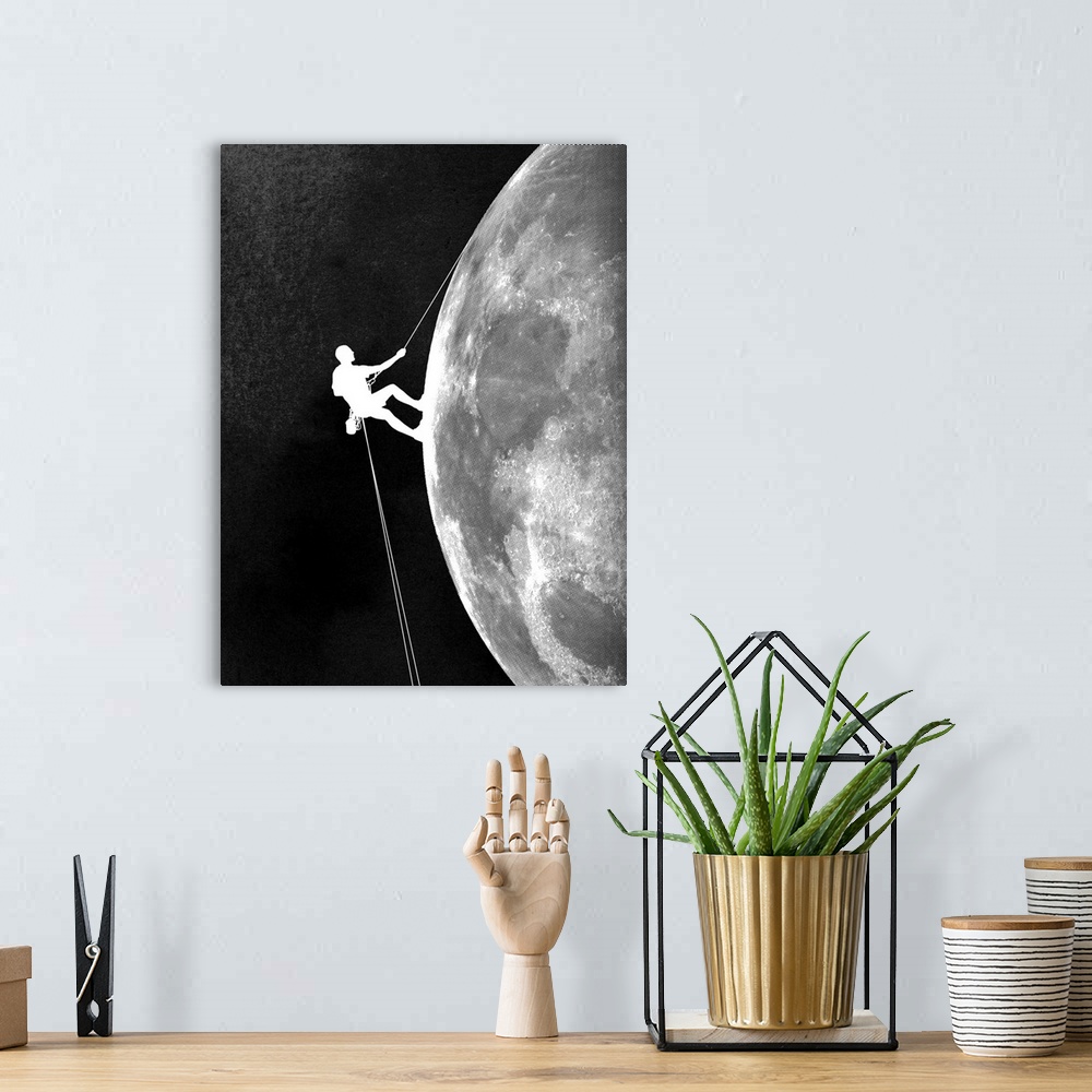 A bohemian room featuring Contemporary artwork in black and white of a climber shown descending down the side of the moon.
