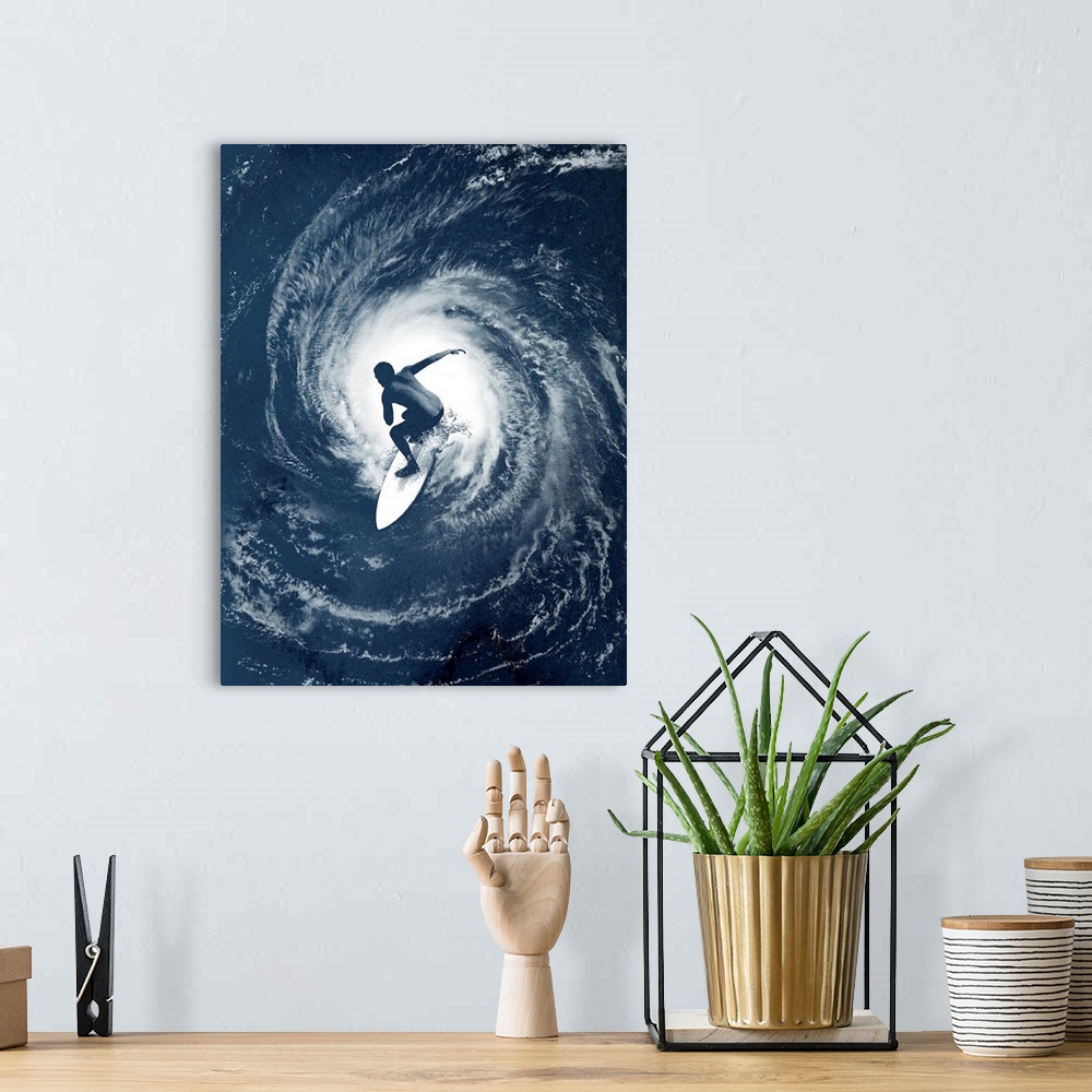A bohemian room featuring Big photo on canvas of a surfer on top of an image of a hurricane in the ocean.
