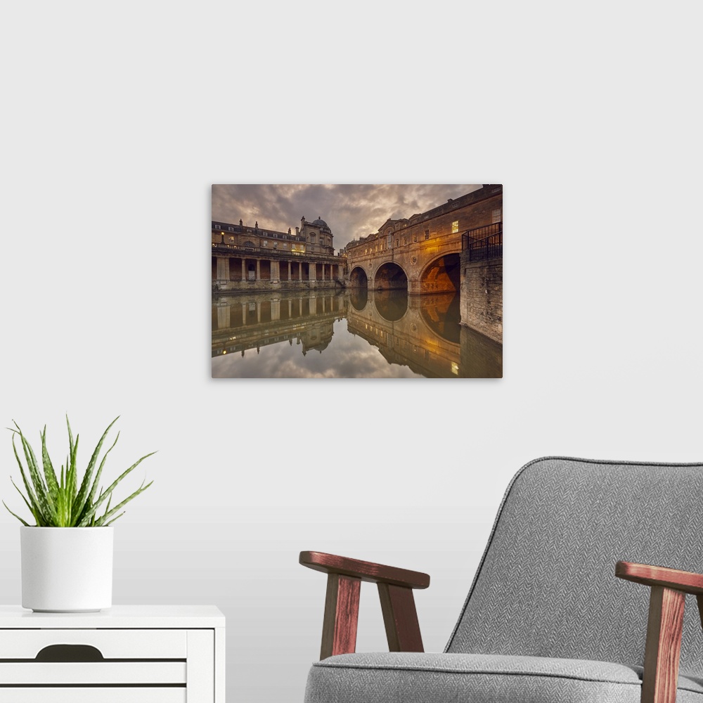 A modern room featuring A dusk view of the unique 18th century Pulteney Bridge spanning the River Avon, in the heart of B...