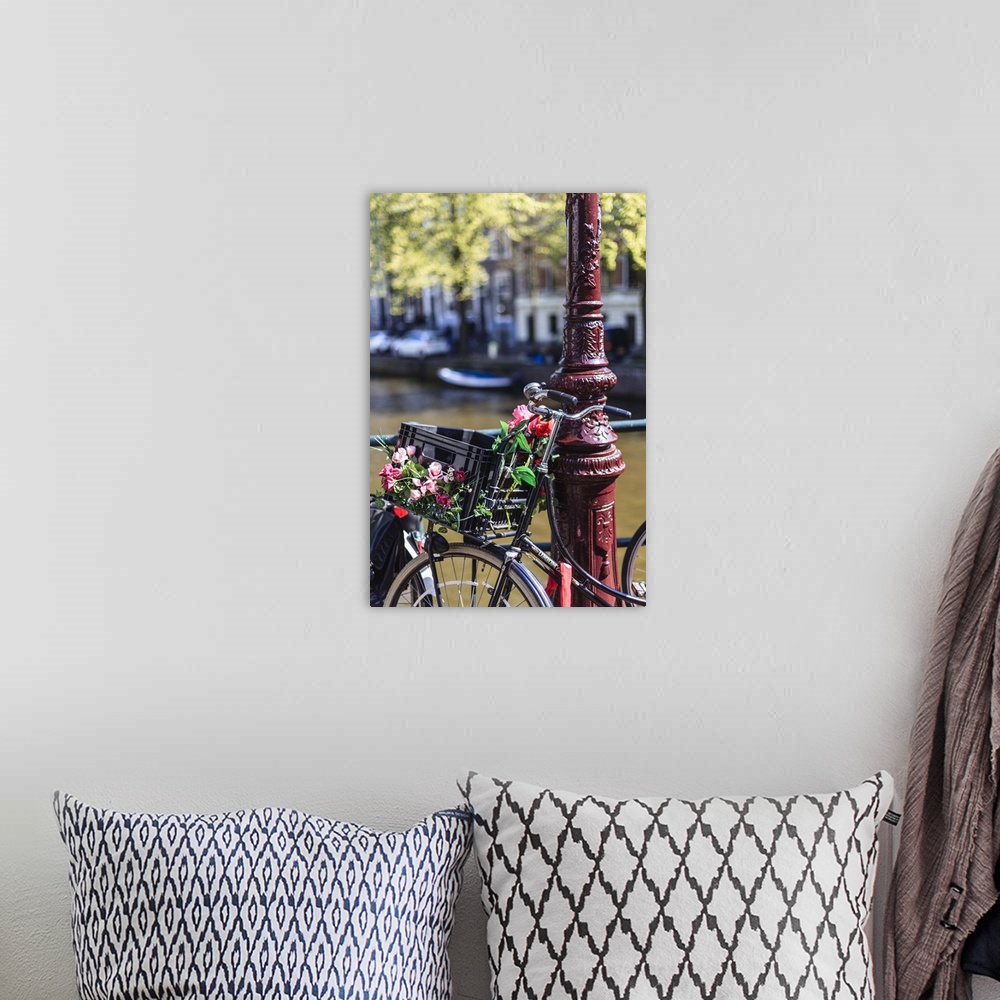 A bohemian room featuring A bicycle decorated with flowers by a canal, Amsterdam, Netherlands
