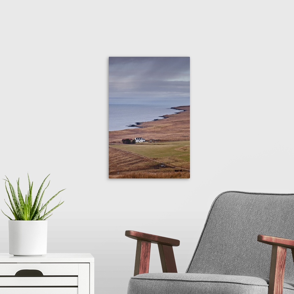 A modern room featuring A solitary house sits on the north west coast of the Isle of Skye, Inner Hebrides, Scotland, Unit...