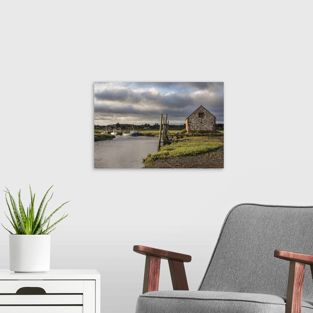 A modern room featuring A view of boats moored in the creek at Thornham, Norfolk, England