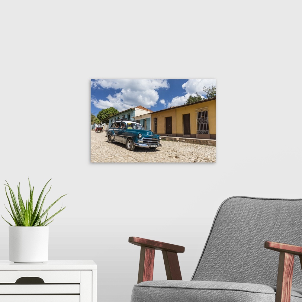 A modern room featuring A vintage 1950's American car working as a taxi in the town of Trinidad, Cuba, West Indies, Carib...