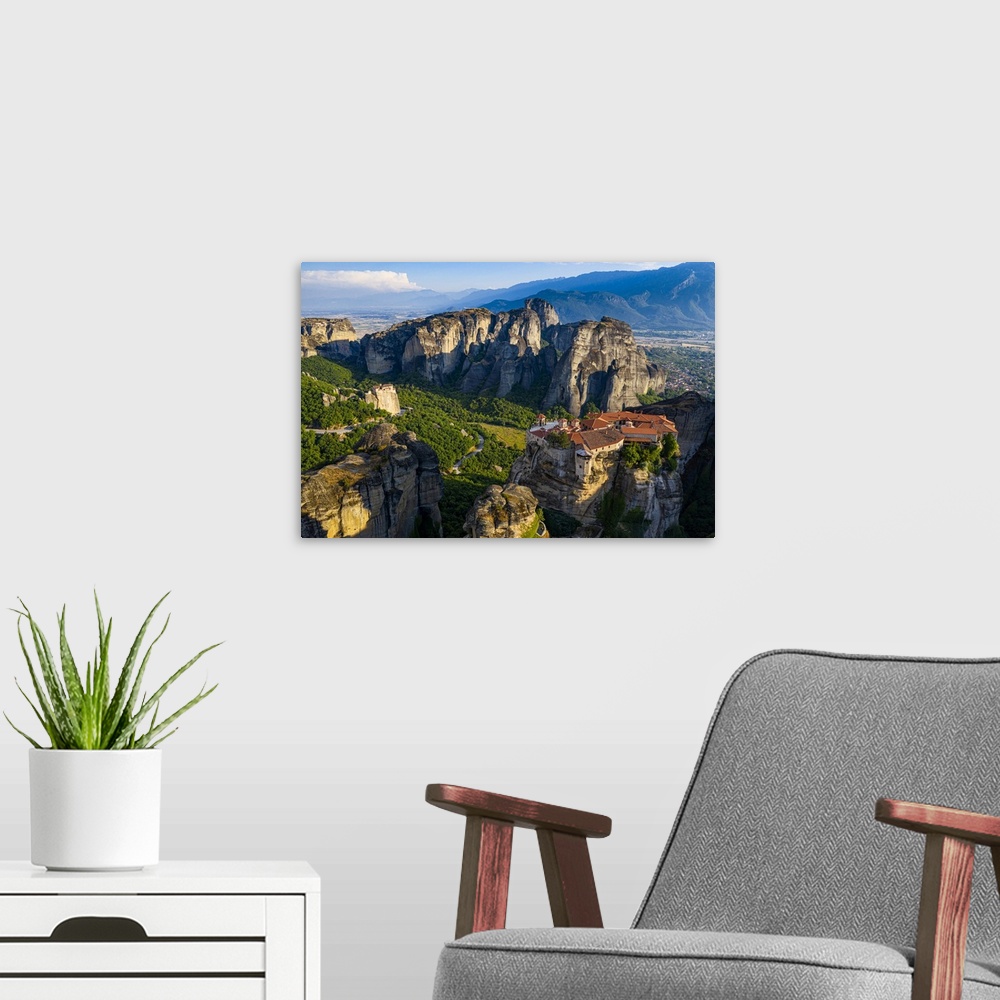 A modern room featuring Aerial by drone of the Holy Monastery of Varlaam at sunrise, UNESCO World Heritage Site, Meteora ...