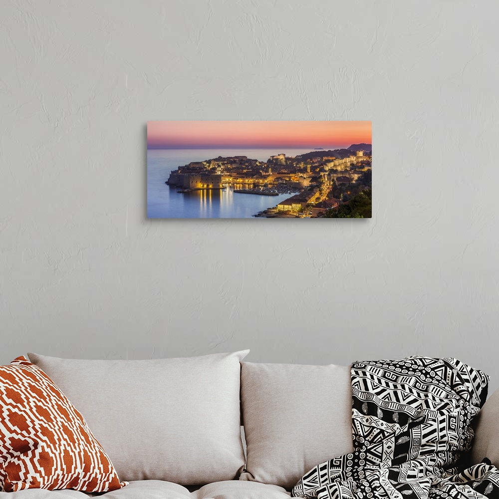 A bohemian room featuring Aerial panorama of Dubrovnik Old Town at night with orange sunset sky, Dubrovnik, Dalmatian Coast...