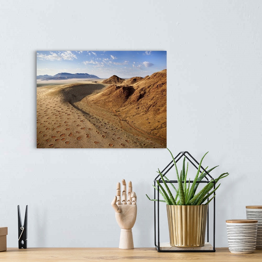 A bohemian room featuring Aerial view from hot air balloon over magnificent desert landscape of sand dunes, mountains and F...