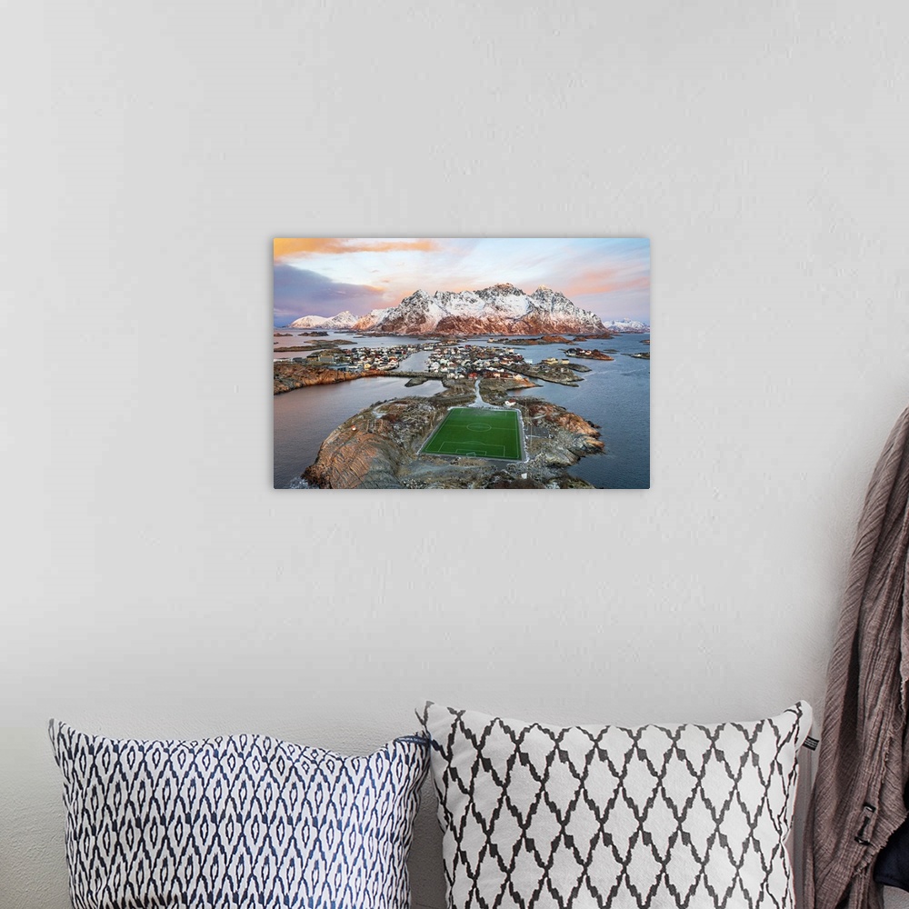 A bohemian room featuring Aerial view of soccer stadium and Henningsvaer village during winter dawn, Nordland county, Lofot...